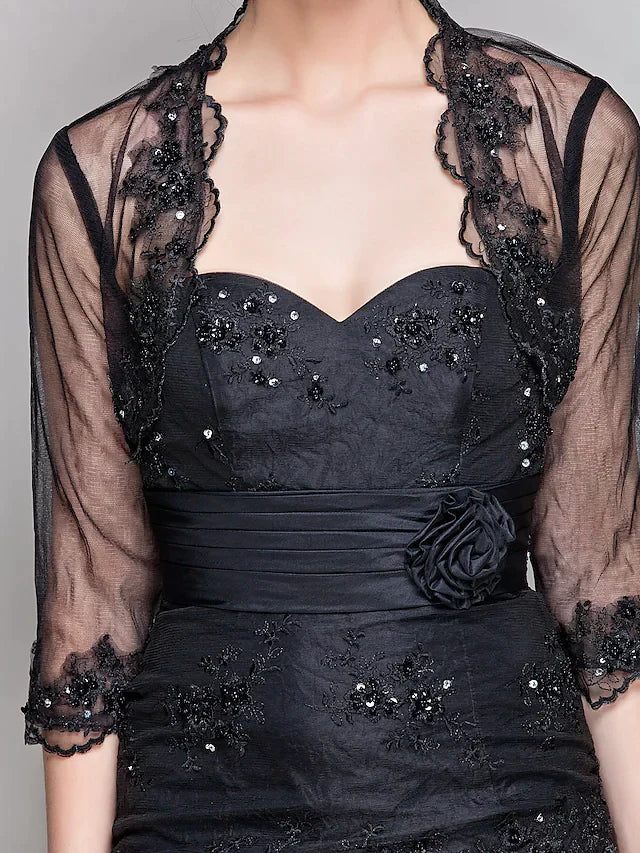 Woman posing gracefully in the Mother of the Bride dress, emphasizing the floor-length taffeta and tulle skirt.
