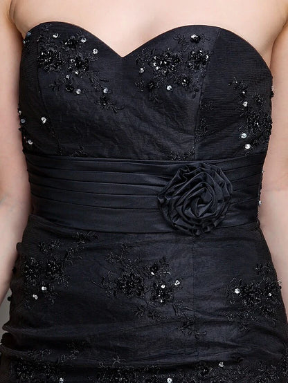 Full view of a woman in the elegant Mother of the Bride dress, showing the overall design and included wrap.