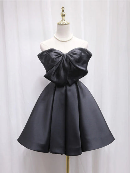 Model wearing a black satin A-line short dress with sweetheart neckline.