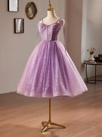Model posing in a purple A-line sweetheart neck tulle lace dress for homecoming.
