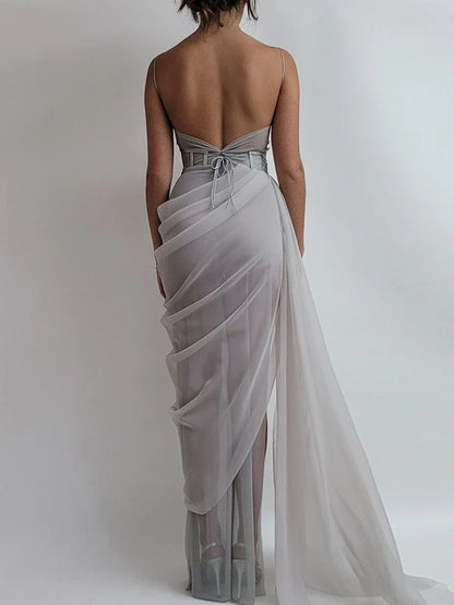 Back view of a flowing periwinkle organza A-line prom dress.