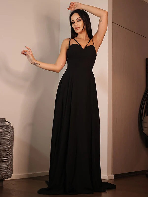Close-up of the sweetheart neckline and ruffled details on the black formal gown.