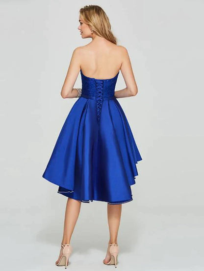 Stylish A-line cocktail dress with sweetheart neckline and pleated satin fabric on a model.