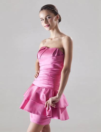 Model posing in the full silhouette of the A-line sweetheart satin mini dress.
