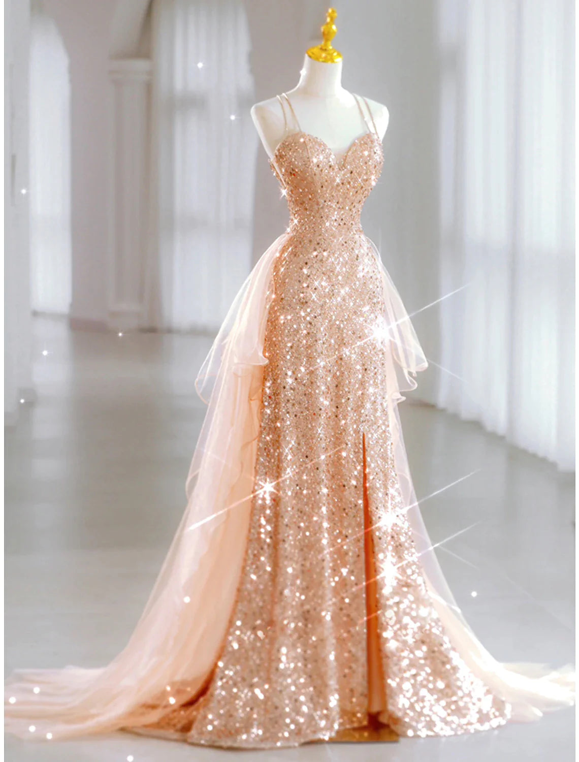 Model posing in a light blue A-line sequin tulle floor-length dress.