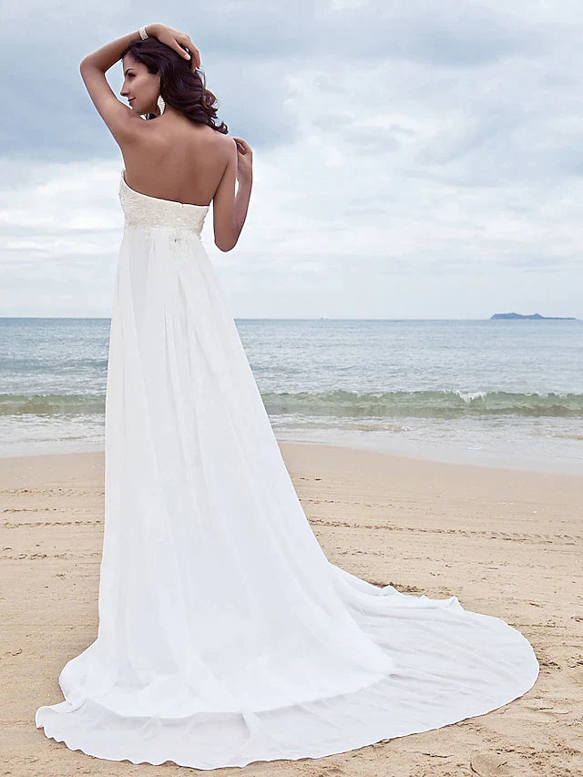 Side view of the A-line strapless chiffon wedding dress, showing the flowing skirt and court train.