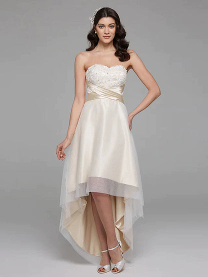Model in elegant A-line strapless wedding dress with sweetheart neckline, floral lace, and a bowknot sash.