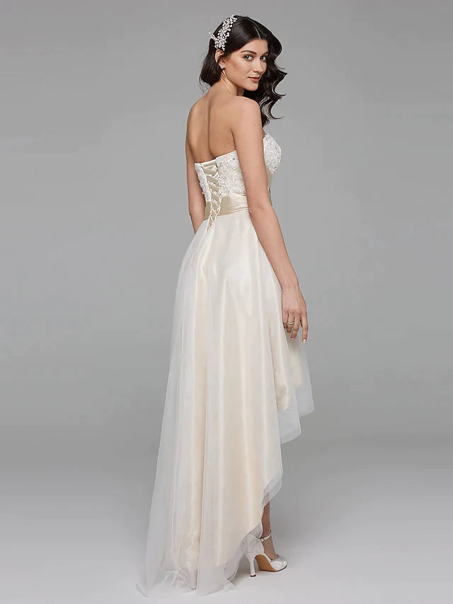 Close-up of the sweetheart neckline and intricate floral lace bodice of the wedding dress.