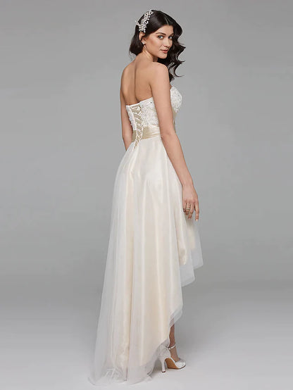 Close-up of the sweetheart neckline and intricate floral lace bodice of the wedding dress.
