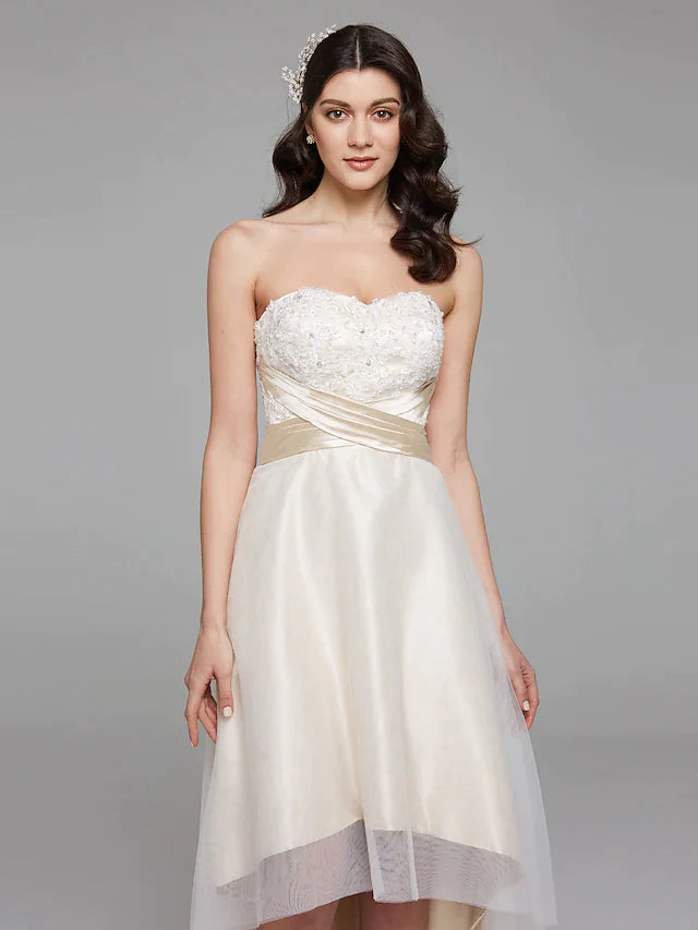 Back view of the A-line wedding dress, featuring a flowing train and elegant bowknot sash.