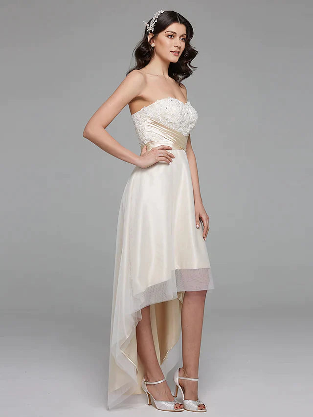 Full length view of a bride posing in a beautiful A-line wedding gown with lace and satin details.