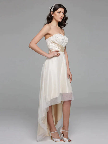 Full length view of a bride posing in a beautiful A-line wedding gown with lace and satin details.