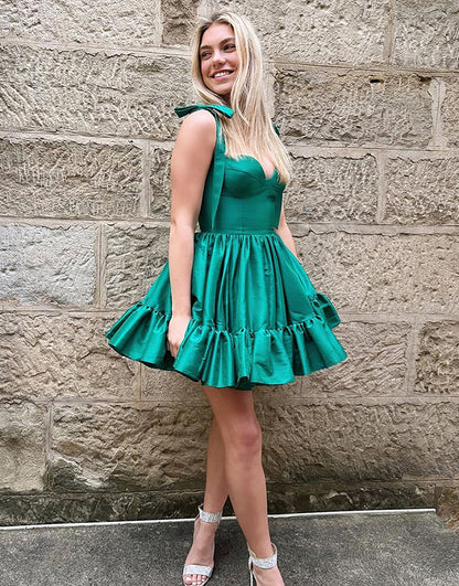 Green A-line short homecoming dress with tie straps.