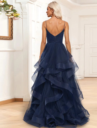 Side view of the A-line tiered evening gown, highlighting the spaghetti straps, ruched details, and flowing organza fabric.