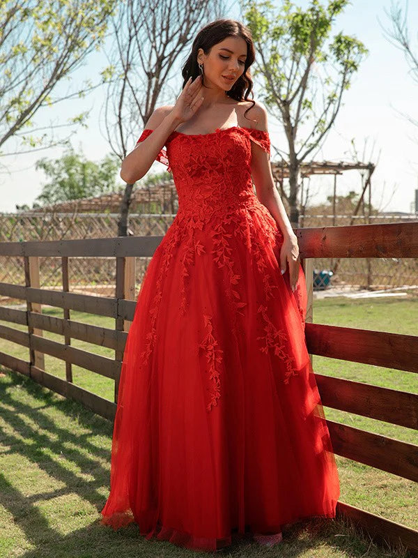 Model wearing an elegant A-line off-shoulder tulle prom dress, front view.