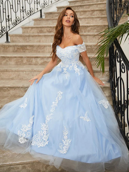 Close-up of the applique detail on the light blue off-shoulder tulle prom dress.