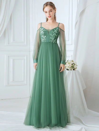 Elegant A-line tulle bridesmaid dress with spaghetti straps and appliques.