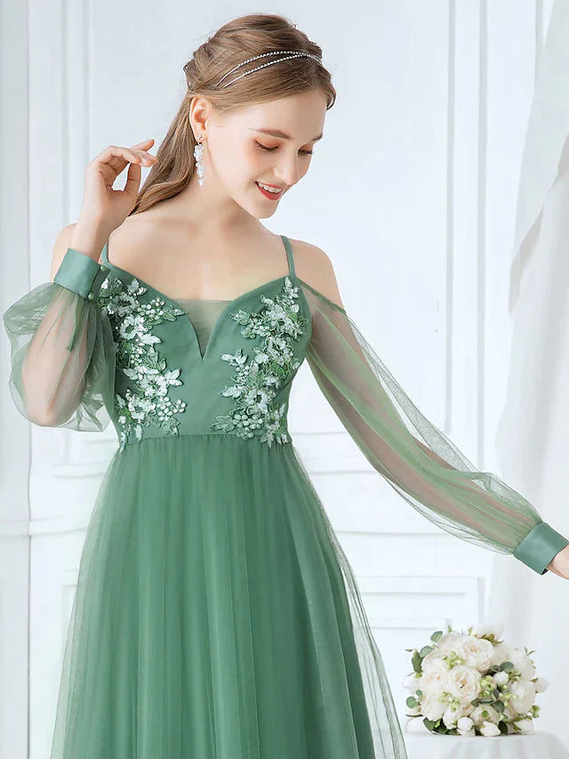 Side profile of A-line tulle dress, showing flowing skirt and appliques.