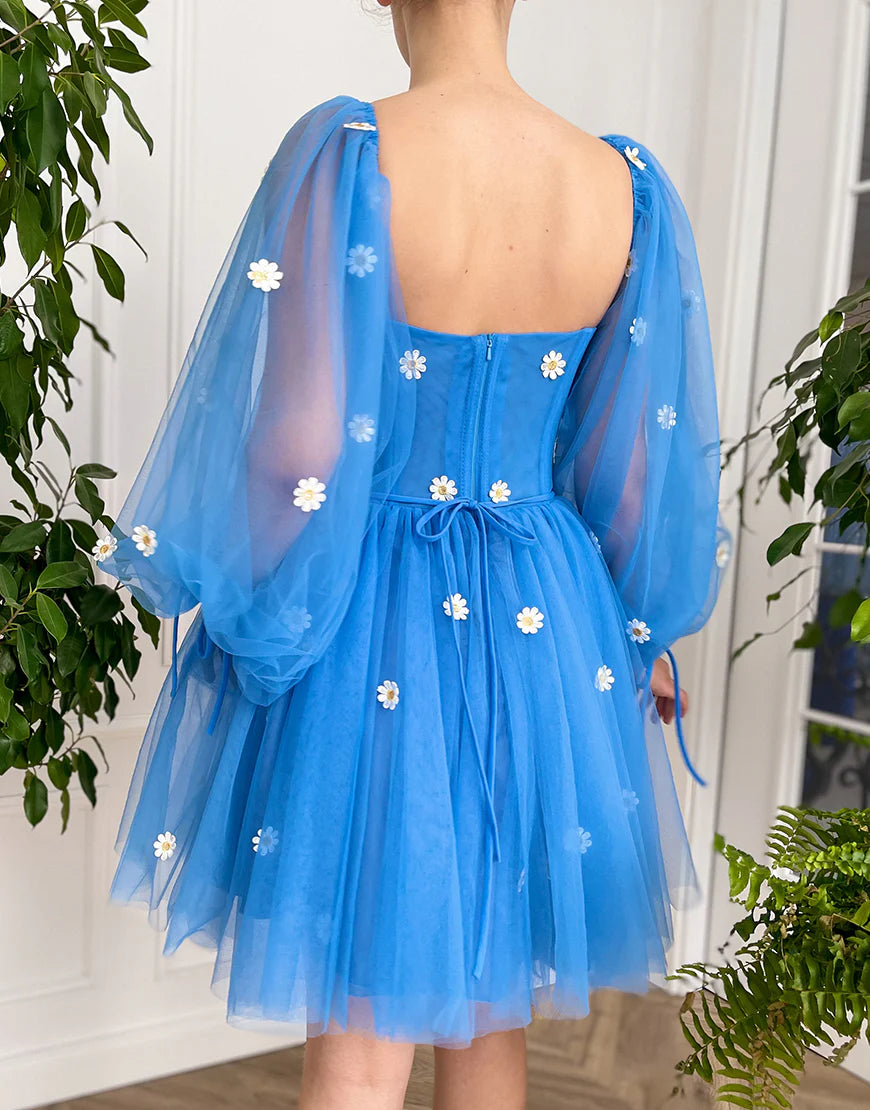 Side view of a model posing in a vibrant blue A-line tulle homecoming dress.