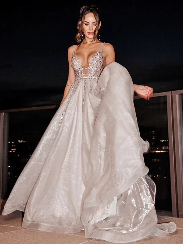 Full view of an elegant light blue A-line V-neck sleeveless beaded tulle prom dress.