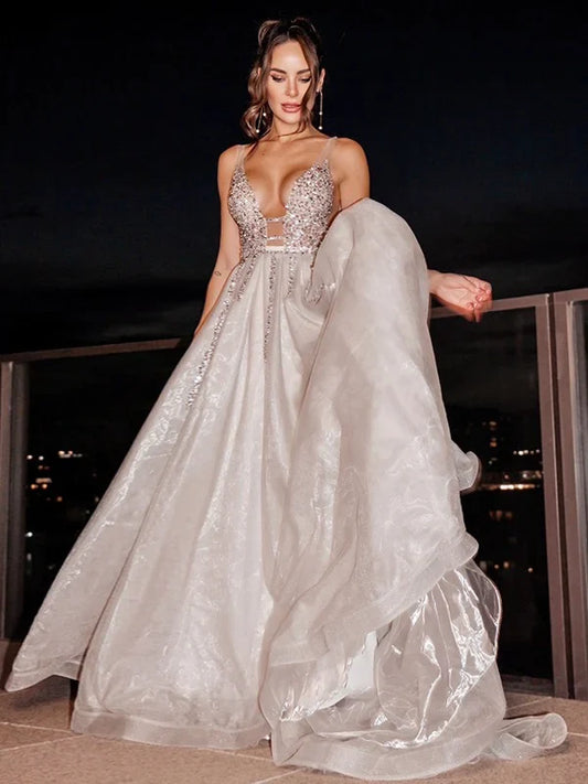 Full view of an elegant light blue A-line V-neck sleeveless beaded tulle prom dress.