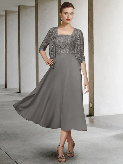 Woman wearing an elegant A-line two-piece Mother of the Bride dress with scoop neck and half sleeves.