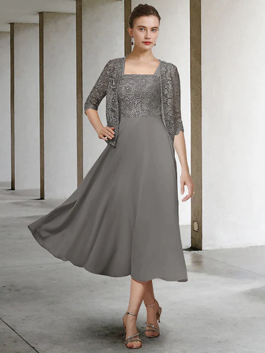Woman wearing an elegant A-line two-piece Mother of the Bride dress with scoop neck and half sleeves.