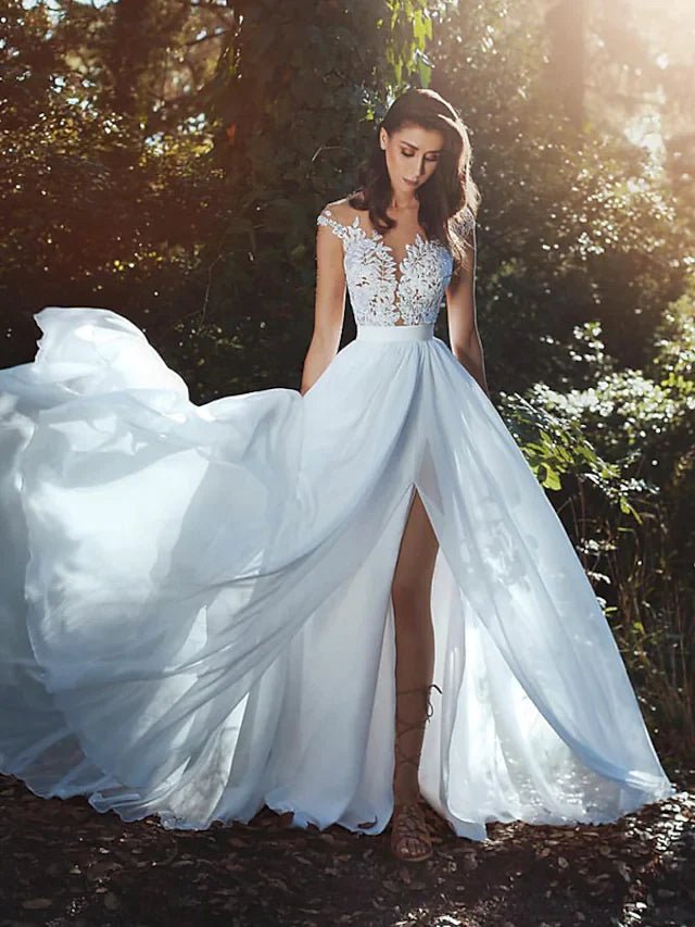 Front view of an elegant A-line V-neck cap sleeve lace wedding dress with a court train.