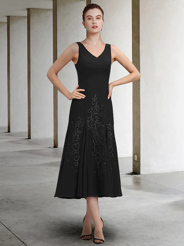 Woman wearing an elegant A-line V-neck chiffon mother of the bride dress with beading.