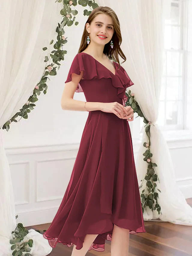 Model in a light blue A-line V-neck knee-length chiffon bridesmaid dress with ruching.
