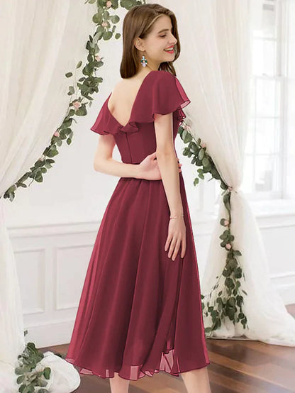Back view of a model wearing a light blue ruched chiffon bridesmaid dress.