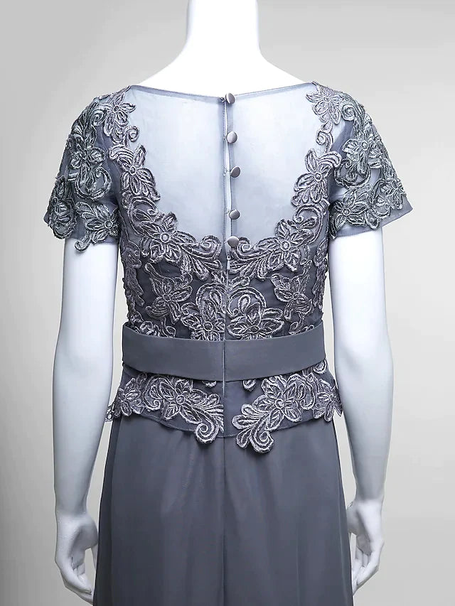 Close-up of the delicate lace bodice and V-neck detail of the dress.