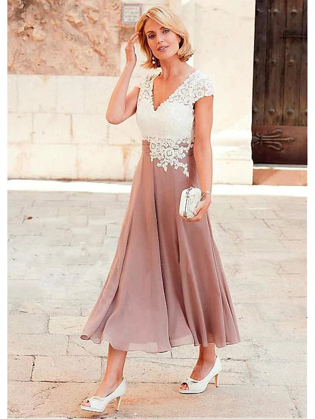 Back view of a plus size A-line V-neck tea length mother of the bride dress with lace details.