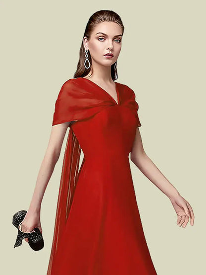 Close-up of the V-neckline and short pleated sleeves of the chiffon dress.