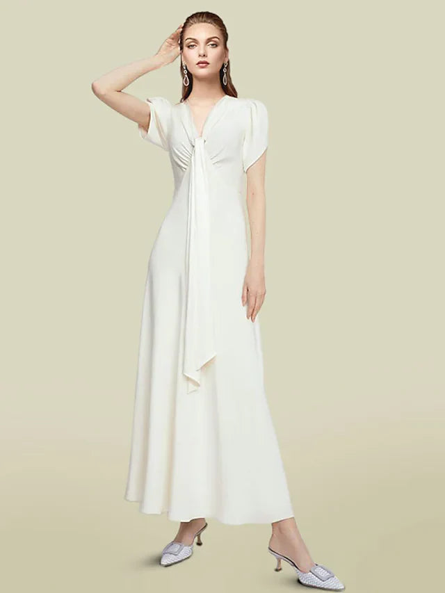 Model wearing an elegant light blue A-line V-neck chiffon mother of the bride dress with short sleeves and ruched waist.