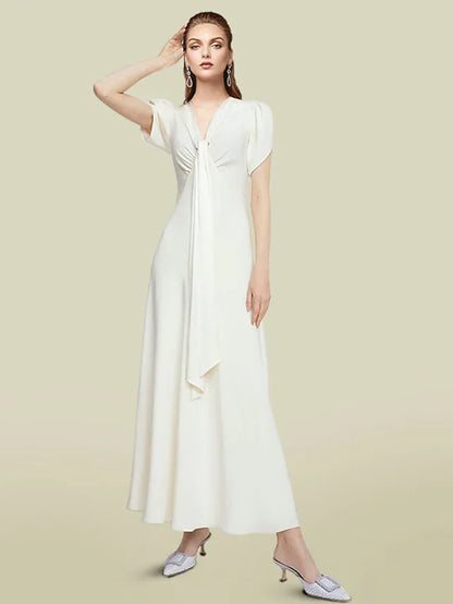 Model wearing an elegant light blue A-line V-neck chiffon mother of the bride dress with short sleeves and ruched waist.