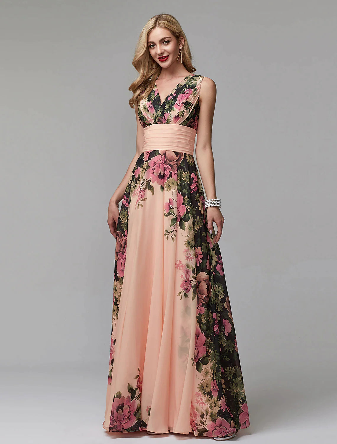 Woman wearing a floral A-line V-neck chiffon gown, posing gracefully.