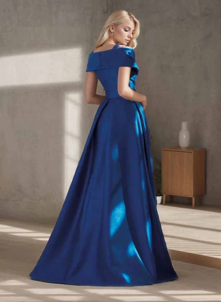 Woman in a navy blue A-line formal gown, side view.