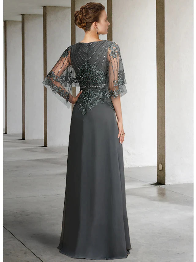 Woman wearing a floor-length navy blue chiffon lace gown with a sash ribbon.