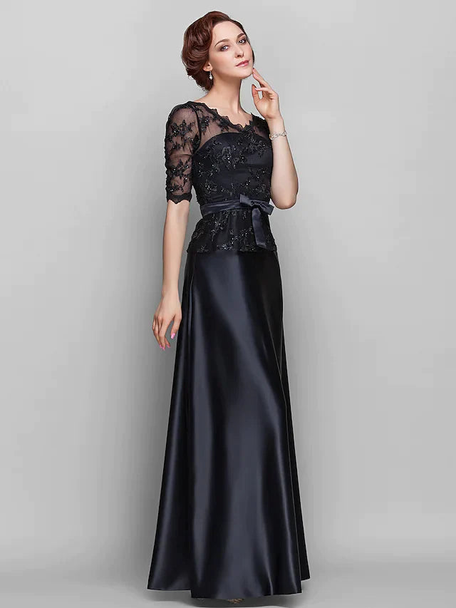 Woman wearing an elegant A-line V-neck Mother of the Bride dress in navy blue, front view.