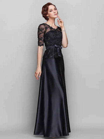 Woman wearing an elegant A-line V-neck Mother of the Bride dress in navy blue, front view.