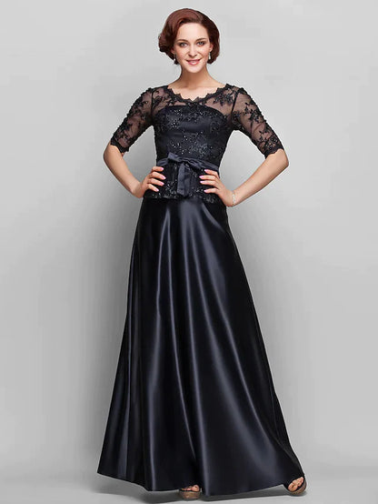 Back view of a woman in a navy A-line Mother of the Bride dress, showcasing the floor-length skirt.