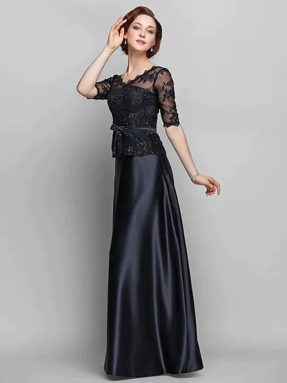 Detailed view of the intricate beading and lace on the bodice of the navy Mother of the Bride dress.