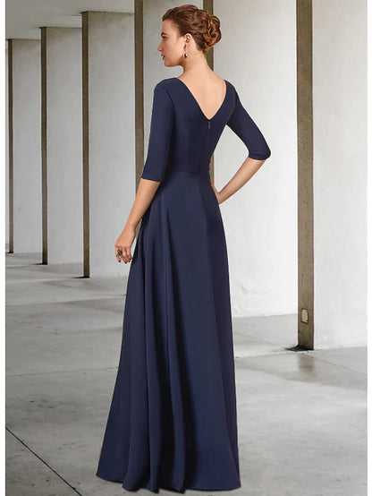 Dark blue floor-length mother of the bride gown featuring a V-neck, half sleeves, and a detailed sash with pleats.