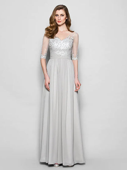 Woman wearing an elegant A-line V-neck half-sleeve Mother of the Bride dress with ruched beading and sequins.