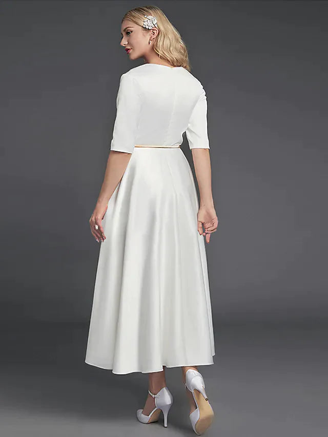 Side view of the A-line satin cocktail dress, showing the tea length and half sleeves.