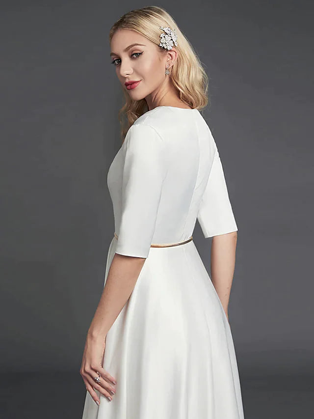 Close-up of the satin fabric and delicate ribbon pleats on the cocktail dress.