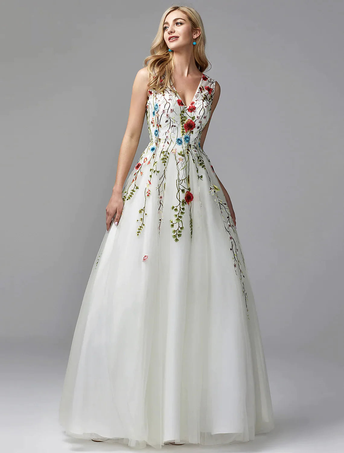 Model wearing a white A-line V-neck lace floor-length dress with embroidery.