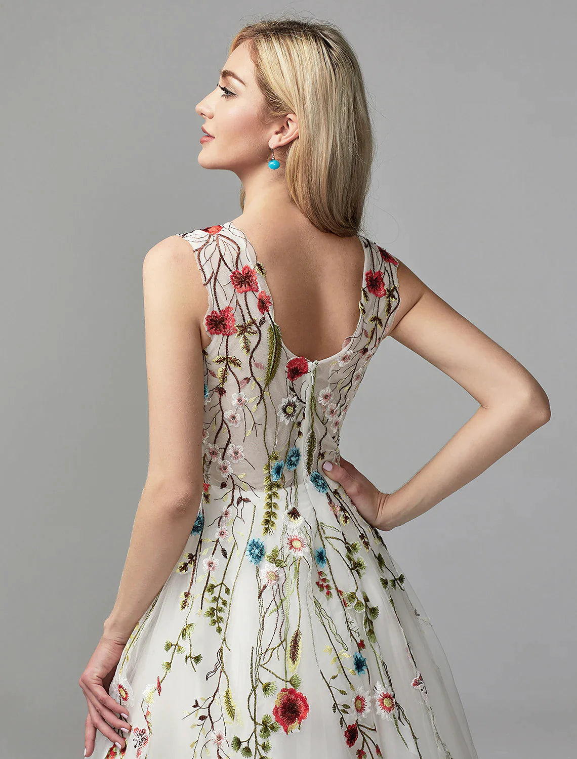 Side view of a model showcasing the flowing skirt of the white A-line dress.