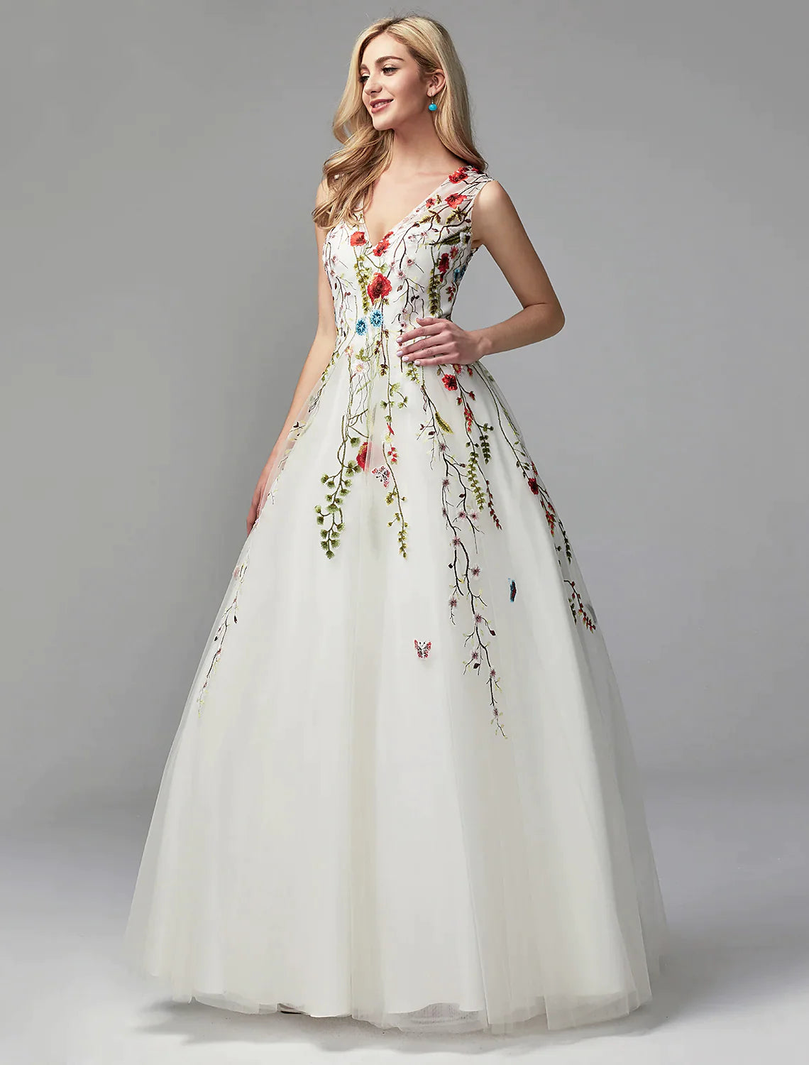 Model posing gracefully in the white sleeveless A-line formal gown.